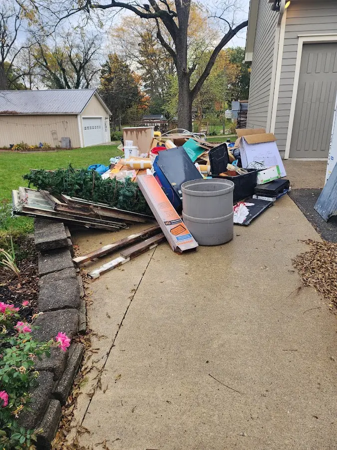 Dumpster being loaded with debris for Estate Cleanout Dumpster Rental in Seagoville